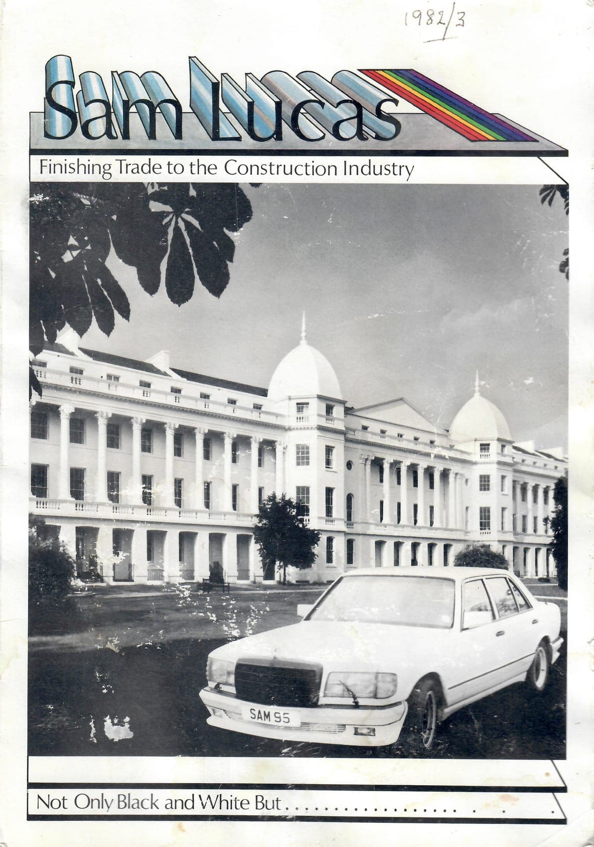 A 1980s brochure cover for Sam Lucas, finishing trade to the construction industry, showing a large white colonnaded building with a white car in front